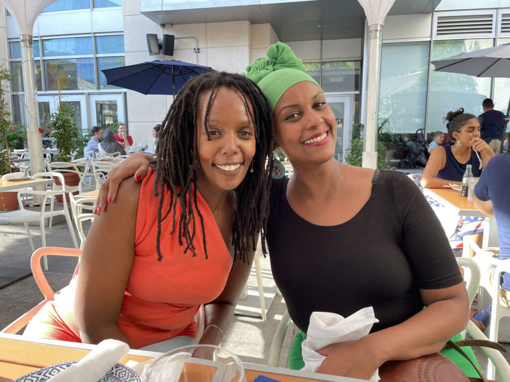 Two black women sitting outside at lunch